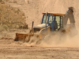 Dusty bulldozer in the field